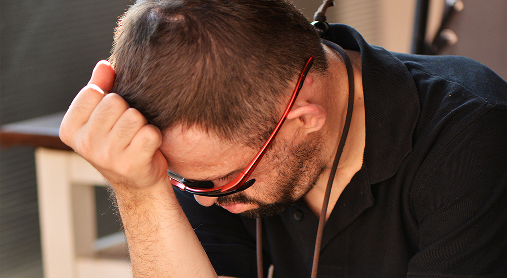 sad man with Down syndrome looking down