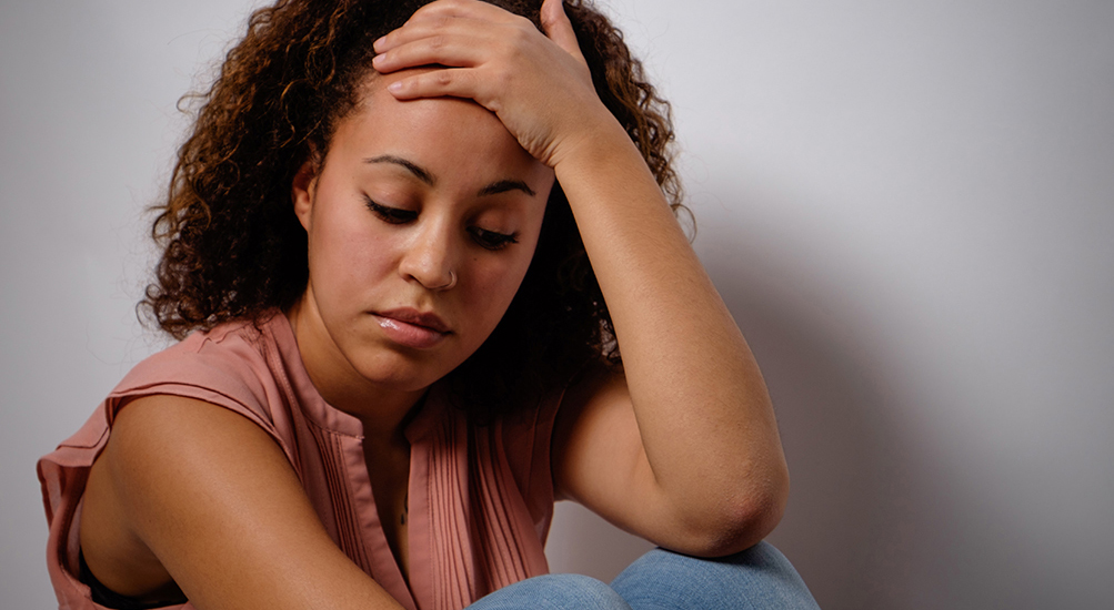 sad woman sitting on the ground